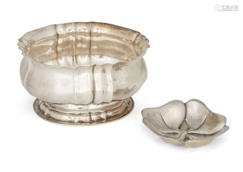 An oval silver bowl, by Buccellati, of hammered design, the scalloped edge to crimped body raised on