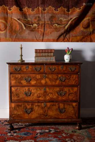 A Queen Anne walnut and feather banded chest of drawers, circa 1710
