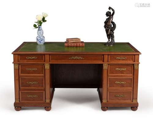 A French 'plum pudding' mahogany and gilt metal mounted pedestal desk, in Empire style, 19th century