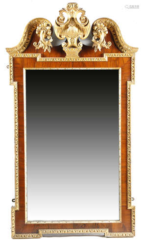 A WALNUT AND GILTWOOD WALL MIRROR IN GEORGE II STYLE 19TH CENTURY the rectangular plate within a