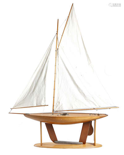 A LARGE POND YACHT LATE 19TH / EARLY 20TH CENTURY with a clinker built hull, cotton sails and