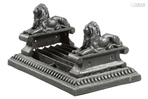 A VICTORIAN BLACK PAINTED CAST IRON BOOT SCRAPER decorated with a pair of recumbent lions and with a