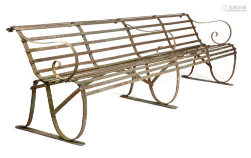 A WROUGHT IRON GARDEN BENCH LATE 19TH CENTURY with a slatted back and seat, with scroll supports