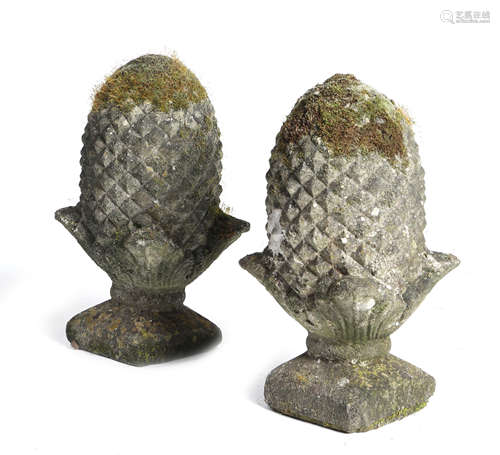 A PAIR OF COMPOSITE STONE GARDEN FINIALS in the form of pineapples (2) 45cm high