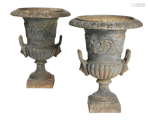 A PAIR OF PAINTED CAST IRON GARDEN URNS 19TH CENTURY the bodies decorated with scrolling leaves