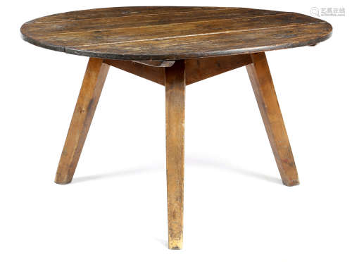A VICTORIAN PINE CRICKET TABLE LATE 19TH CENTURY the circular boarded top on tapering legs 72.7cm
