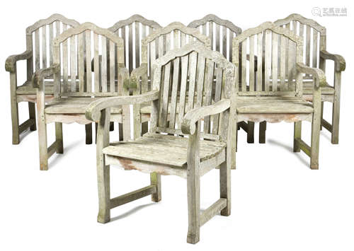 A SET OF EIGHT TEAK GARDEN ARMCHAIRS LATE 20TH CENTURY each with a slatted back and seat (8)