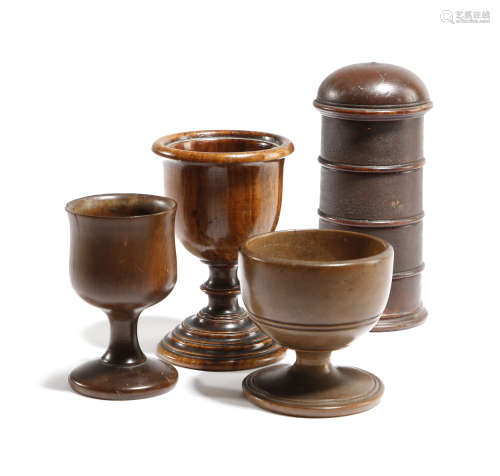 AN EARLY 19TH CENTURY TREEN SPICE TOWER together with a treen walnut turned egg cup and two other