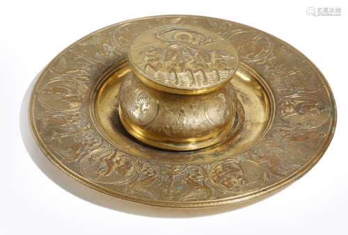 A FRENCH GILT BRASS INKWELL LATE 19TH CENTURY decorated with classical subjects, the hinged lid with