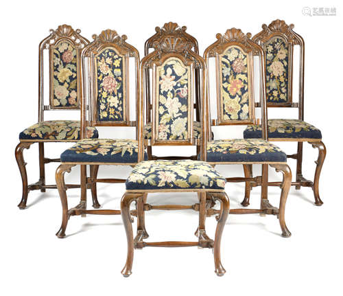 A SET OF SIX 18TH CENTURY WALNUT AND BEECH SIDE CHAIRS POSSIBLY DUTCH each with a scroll and shell