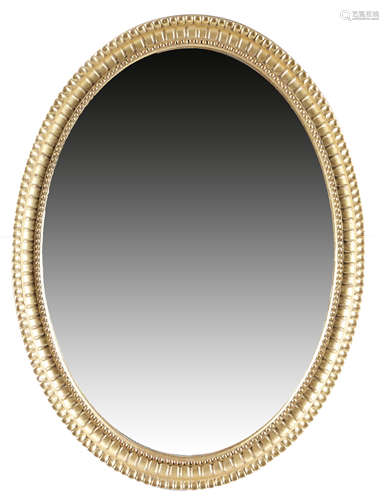 A GEORGE III GILTWOOD OVAL WALL MIRROR c.1790 the oval plate within a beaded and fluted moulded