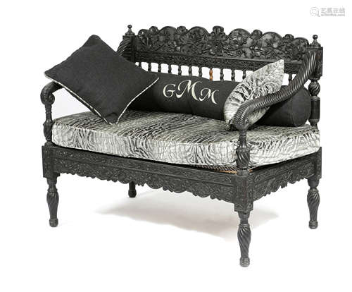 AN ANGLO-INDIAN EBONISED HARDWOOD SETTEE POSSIBLY GOAN, 19TH CENTURY carved with scrolling leaves