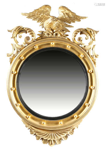 A GILTWOOD WALL MIRROR IN REGENCY STYLE 19TH CENTURY the circular plate within a reeded slip and a