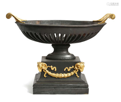 A CAST IRON AND GILT BRONZE MOUNTED BASKET FIRE GRATE REGENCY STYLE of navette shape, with leaf