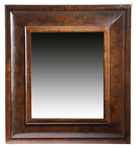 A WILLIAM AND MARY WALNUT AND OYSTER VENEERED CUSHION FRAME WALL MIRROR LATE 17TH / EARLY 18TH