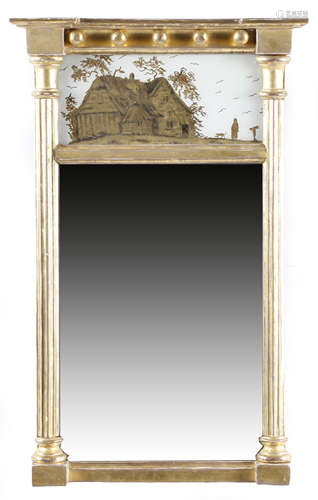 A REGENCY GILTWOOD PIER MIRROR EARLY 19TH CENTURY the rectangular plate flanked by fluted columns