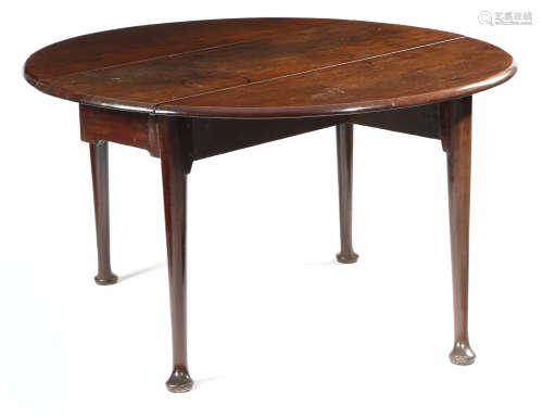 A GEORGE II MAHOGANY DINING TABLE c.1740-50 the oval drop-leaf top above turned club legs and pad
