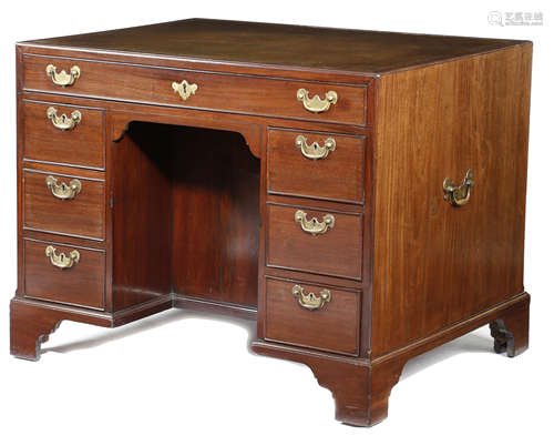 A GEORGE II MAHOGANY KNEEHOLE DESK MID-18TH CENTURY the caddy moulded edge top inset with a later