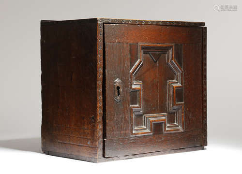 A CHARLES II OAK HANGING SPICE CUPBOARD LATE 17TH CENTURY with punched star decoration, the hinged