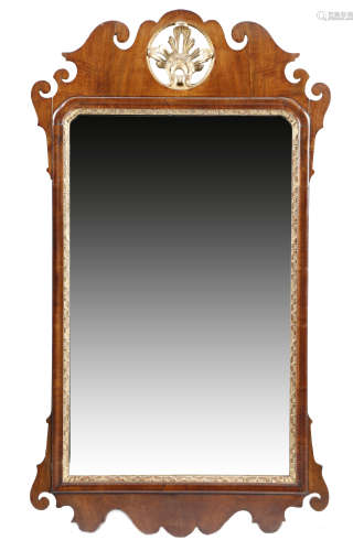 A GEORGE II WALNUT AND PARCEL GILT FRET FRAME WALL MIRROR the bevelled plate with arched top