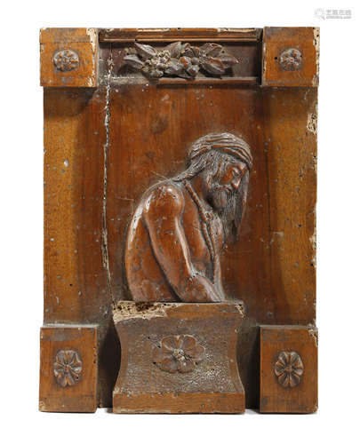 AN ITALIAN CARVED WALNUT RELIEF OF A SLAVE PROBABLY LATE 17TH / EARLY 18TH CENTURY the bearded