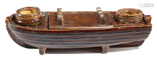 A VICTORIAN POTTERY INKSTAND IN THE FORM OF A BARGE LATE 19TH CENTURY with a treacle glaze, with