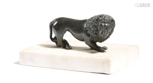 AN ITALIAN BRONZE GRAND TOUR MODEL OF A PACING LION mounted on a white marble base 12cm wide