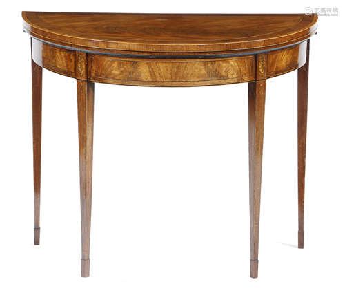 A GEORGE III MAHOGANY DEMI-LUNE CARD TABLE c.1790 inlaid with stringing, the hinged fold-over top