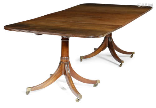 A MAHOGANY TWIN PEDESTAL DINING TABLE IN REGENCY STYLE 20TH CENTURY the reeded edge top with two