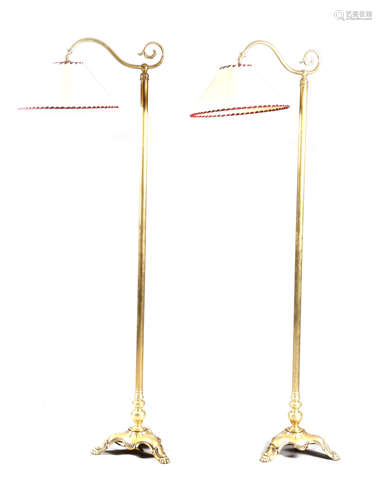 A PAIR OF BRASS STANDARD LAMPS LATE 19TH / EARLY 20TH CENTURY each with a scroll arm, a turned