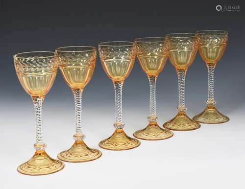 A set of six Stuart amber and clear glass wine glasses, amber glass shallow foot support clear