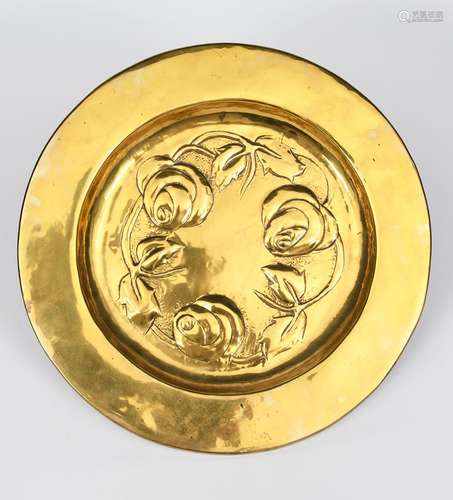 A Glasgow School brass charger, stamped in low relief to the well with three rose flower unsigned,