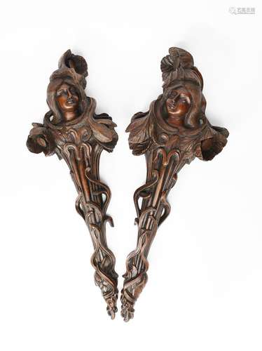 A pair of Art Nouveau carved figures, each modelled as a maiden emerging from a flower stem,