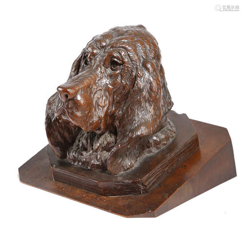 A BLACK FOREST CARVED WOOD HEAD OF A BLOODHOUND LATE 19TH CENTURY mounted on a walnut plinth 20.