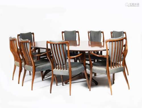 λ A rosewood veneer sideboard, extending dining table and eight chairs designed by Andrew John