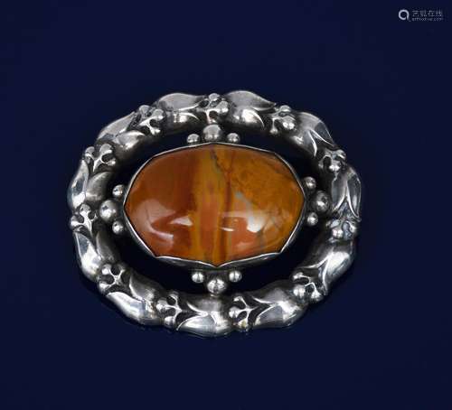 A Georg Jensen silver and agate brooch designed by George Jensen, model no.108, pierced and cast