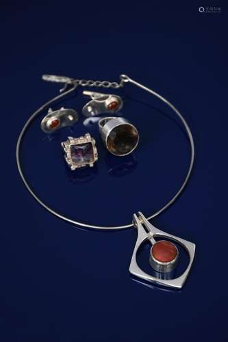 A silver pendant on neck ring, pierced and cast open diamond shape set with central amber coloured