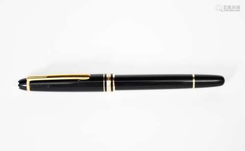 A Mont Blanc Meisterstuck ball pen, black with yellow metal bands and clip, 13.5cm. long