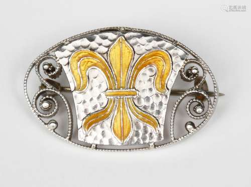 A Murrle Bennett silver and enamel brooch, oval, pierced form cast with scrolls and central fleur de