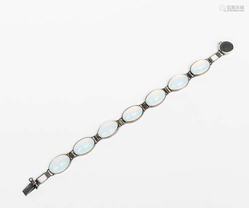 A silver and moonstone bracelet, comprising seven oval stones, with silver clasp, indistinct stamped