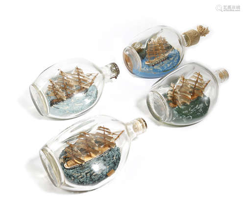 FOUR SHIPS IN A BOTTLE FIRST HALF 20TH CENTURY depicting sailing ships, three in full sail, one