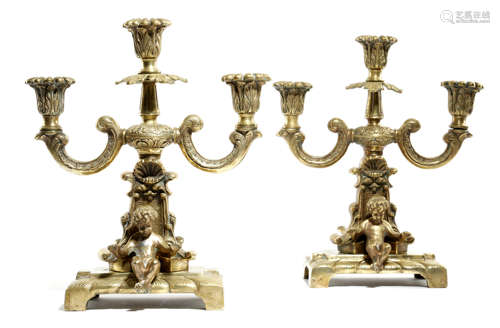 A PAIR OF 19TH CENTURY FRENCH BRONZE CANDELABRA each modelled with two cherubs, with scrolling