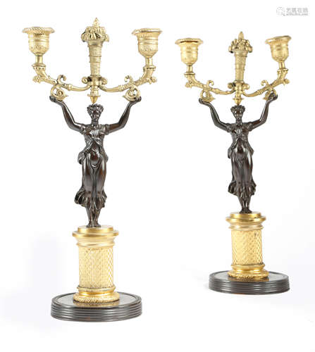 A PAIR OF FRENCH GILT PATINATED BRONZE FIGURAL TWIN-LIGHT CANDLESTICKS EARLY 19TH CENTURY each