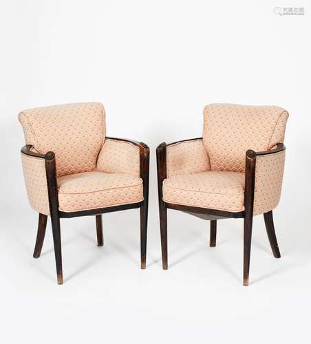 A pair of Hille walnut arm-chairs, tapering legs rising to carved scroll terminal, with pink