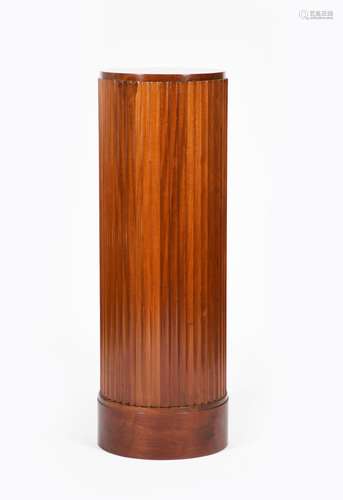 A mahogany fluted cylindrical pedestal, on drum base, 116cm. high, 38.5cm. diam.