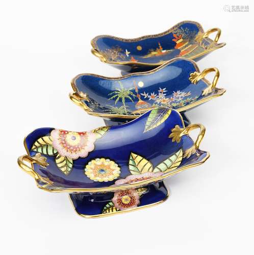 A Carlton Ware twin-handled footed dish, printed and painted in colours and gilt on a deep blue