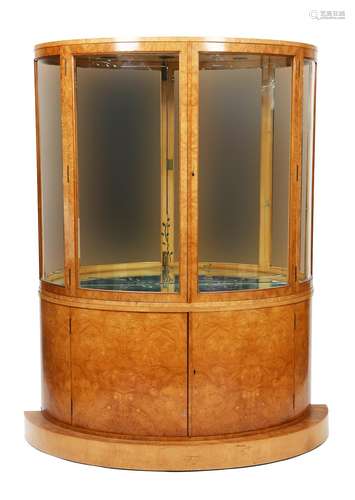 A walnut veneer bow-fronted display cabinet, the curved, hinged doors with curved glass etched