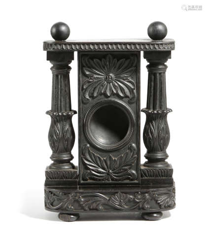 AN ANGLO-INDIAN EBONY WATCHSTAND PROBABLY CEYLONESE, MID-19TH CENTURY carved with scrolling leaves
