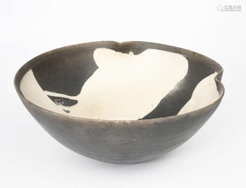 Martin Smith (born 1950) a raku bowl with pinched rim, matt black body resist decorated with white