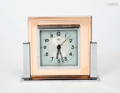 A DEP Savoy desk alarm clock, chrome Odeon style stand supporting peach tinted glass body, with